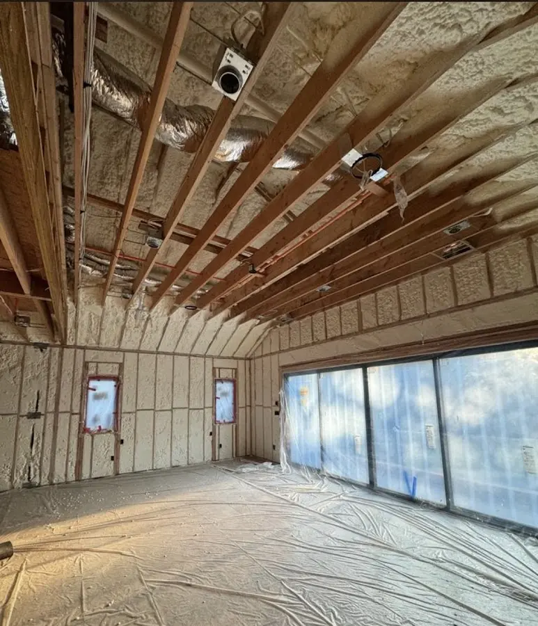 Interior walls and ceiling insulated with spray foam during new construction in Burlington